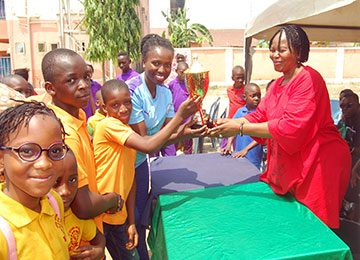 winning house receiving trophy from proprietress